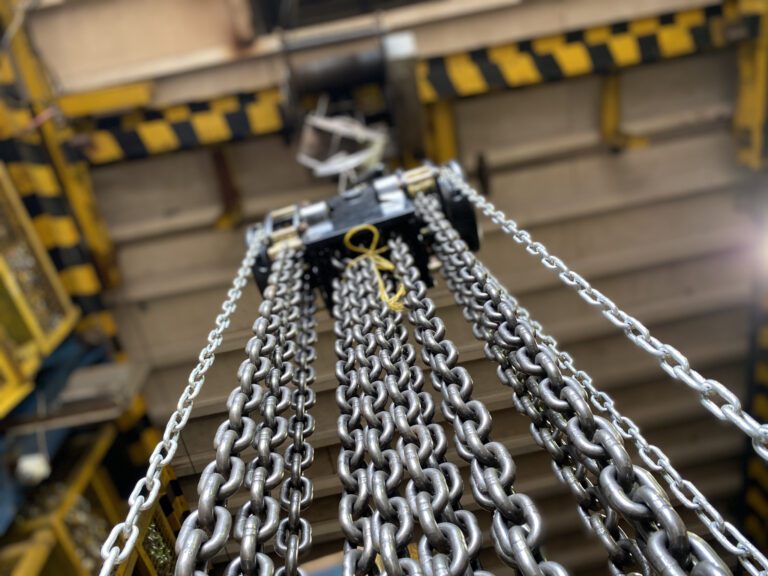 Multi-leg steel chain slings hanging in the works