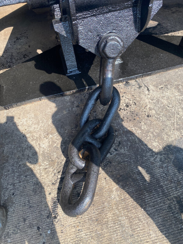 A joining shackle making up two shots of stud link anchor chain on the ground